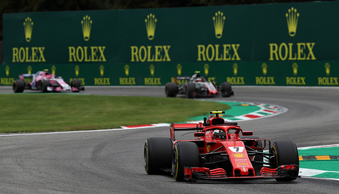 Formula 1 Race Cars with Rolex Signage in Background