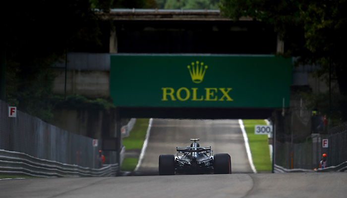 Formula 1 Race Cars with Rolex Signage in Background