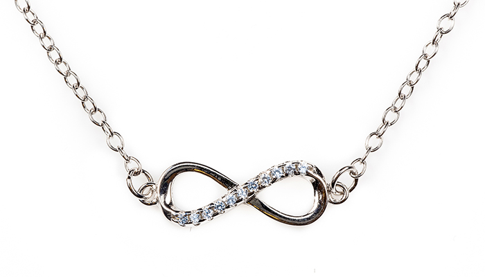 Silver infinity pendant with blue diamonds on a chain