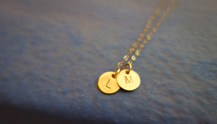 Yellow gold pendant necklaces engraved with initials