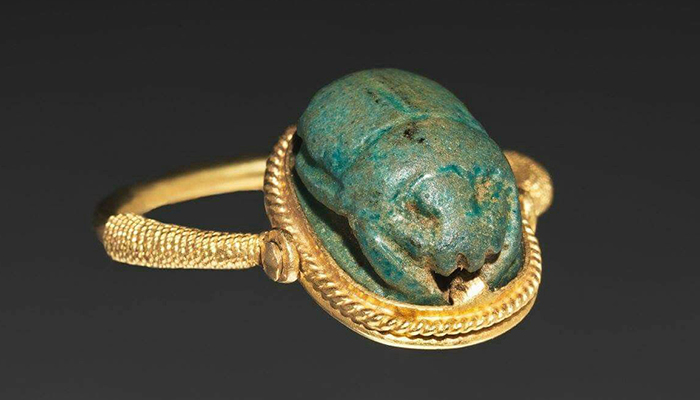 Ancient Egyptian jewelry, featuring a scarab motif, carved out of turquoise