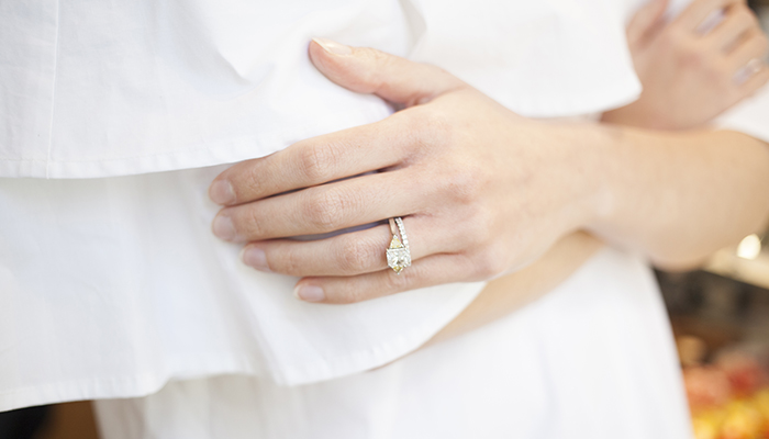 Engagement ring on woman's hand.