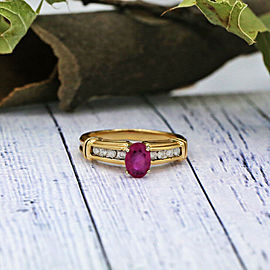 Yellow Gold Engagement ring features center oval cut Ruby and 0.12ct of TCW DIA